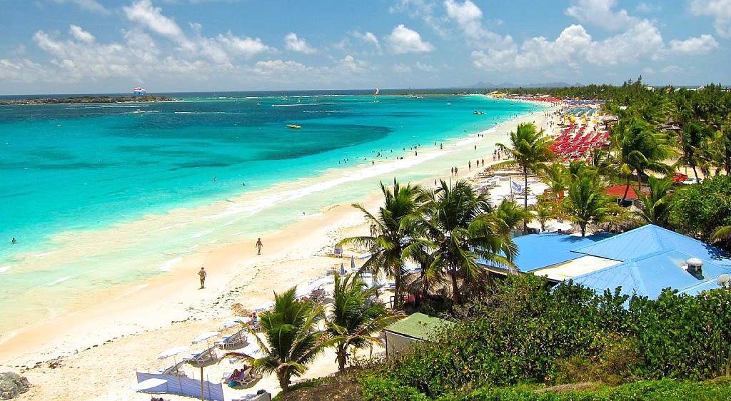 Try all sort of water sports, walk down the mile long beach or go top off at the nudist section of Orient Beach!