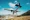 Plane lands over a hill to St. Barts Airport