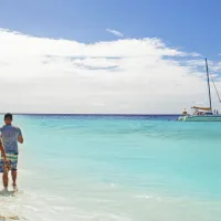 Friends walk on the beach in Klein Curacao in 2025